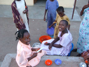 Click for full size image of students helping prepare food for meal